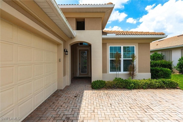 view of exterior entry with a garage