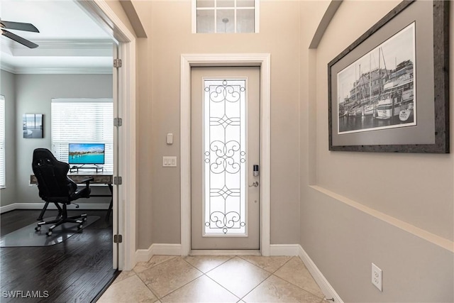 entryway featuring ornamental molding, ceiling fan, and light tile patterned flooring