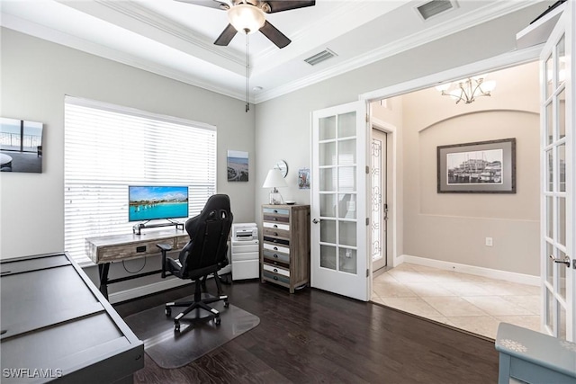 office area featuring french doors, ceiling fan with notable chandelier, dark wood-type flooring, and ornamental molding