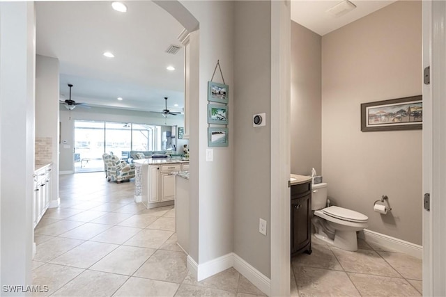 bathroom featuring tile patterned flooring, ceiling fan, and toilet