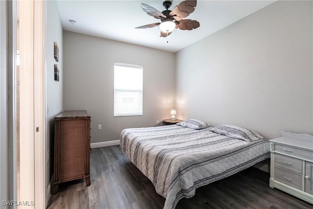 bedroom with dark hardwood / wood-style floors and ceiling fan