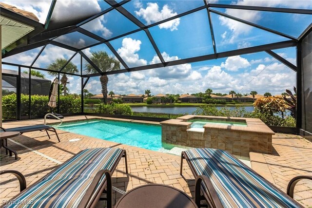 view of swimming pool featuring glass enclosure, an in ground hot tub, a water view, and a patio