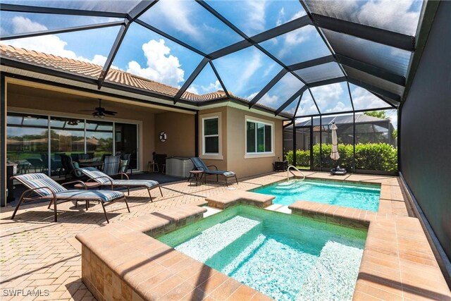 view of swimming pool with a lanai, a patio area, and ceiling fan