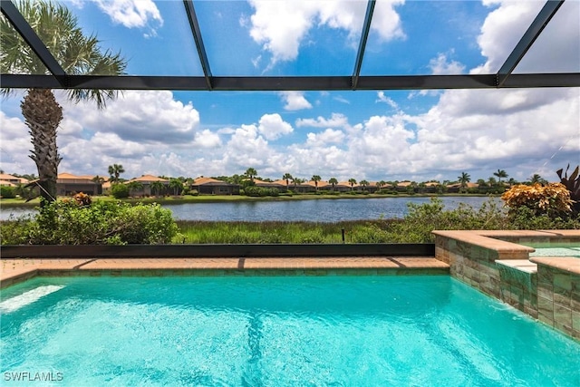 view of pool with a water view and glass enclosure