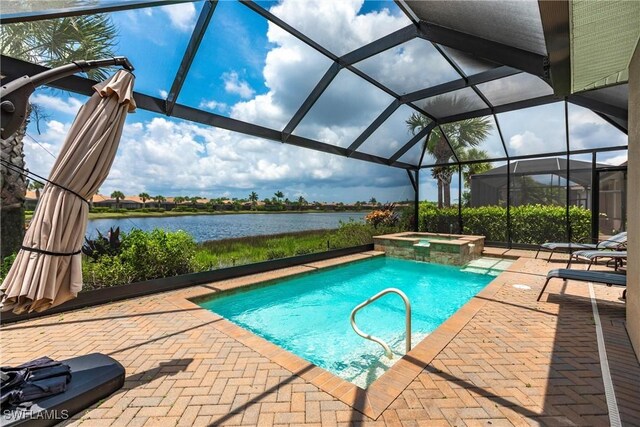 view of swimming pool with a lanai, a patio area, an in ground hot tub, and a water view