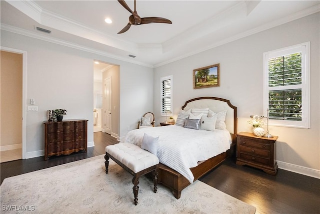 bedroom with ceiling fan, a tray ceiling, and multiple windows