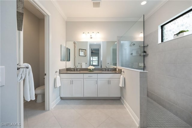 bathroom featuring toilet, crown molding, plenty of natural light, and vanity