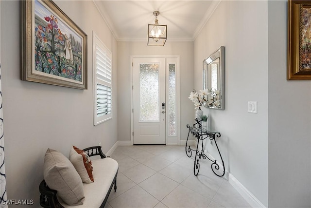 tiled entryway with a chandelier and ornamental molding