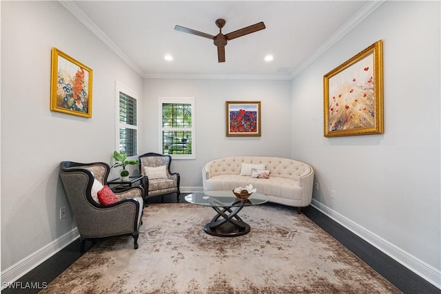 living area with ceiling fan, hardwood / wood-style floors, and ornamental molding