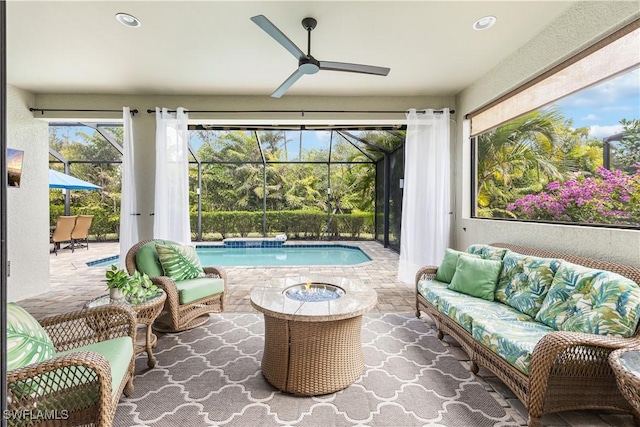 sunroom with ceiling fan and a swimming pool