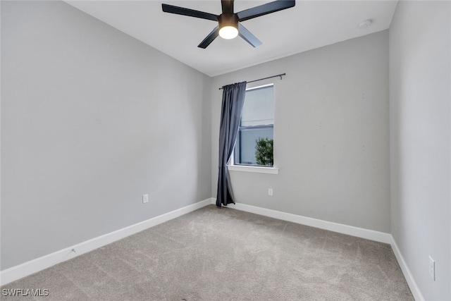 spare room with baseboards, a ceiling fan, and carpet flooring