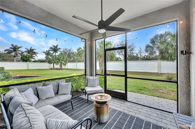 sunroom with a ceiling fan