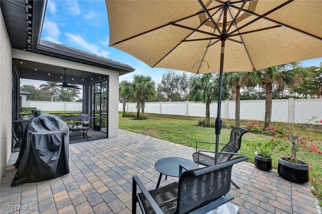 view of patio / terrace featuring a fenced backyard and a sunroom