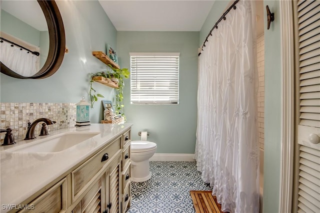 bathroom with tile patterned flooring, vanity, tasteful backsplash, and toilet