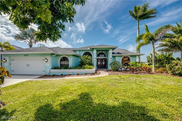 view of front of home featuring a garage, a front yard, and french doors