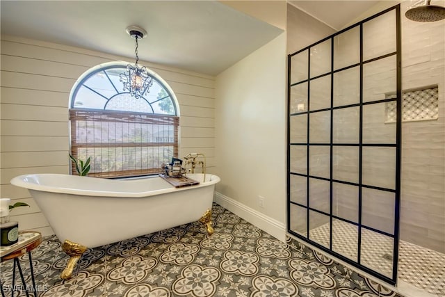 bathroom with wood walls, separate shower and tub, and an inviting chandelier