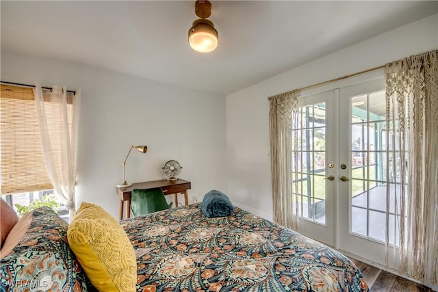 bedroom with access to exterior, multiple windows, and french doors