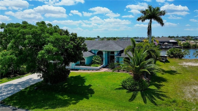 view of front facade with a front yard and a water view