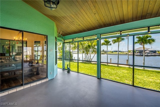 unfurnished sunroom featuring a water view, wood ceiling, vaulted ceiling, and a notable chandelier