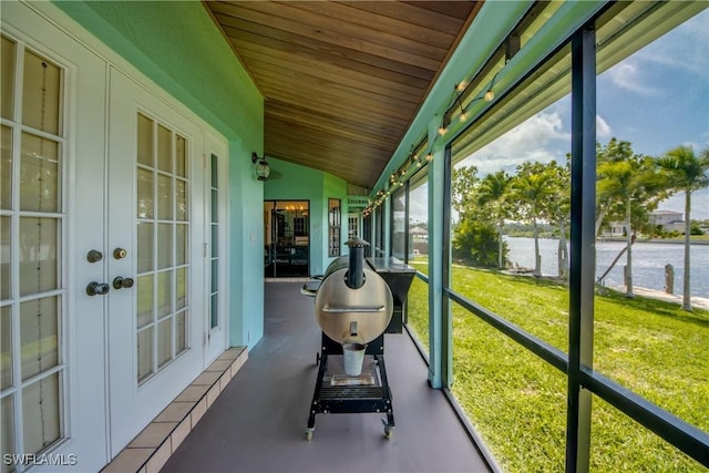 unfurnished sunroom featuring wooden ceiling and vaulted ceiling