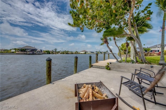 view of dock featuring a water view and an outdoor fire pit