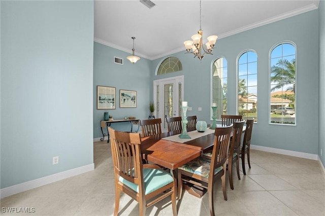 dining space with ornamental molding, light tile patterned floors, and a chandelier