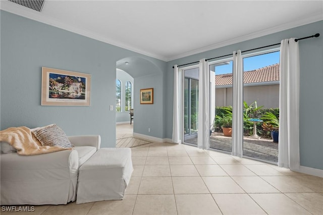 sitting room with light tile patterned floors and crown molding