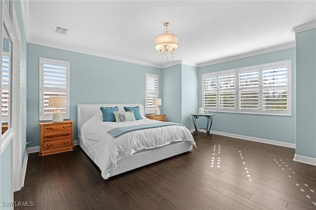 bedroom featuring ornamental molding, a notable chandelier, and dark hardwood / wood-style flooring