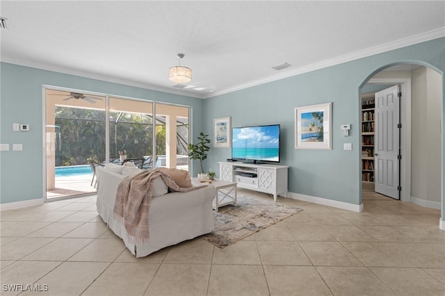 living room featuring light tile patterned floors and ornamental molding