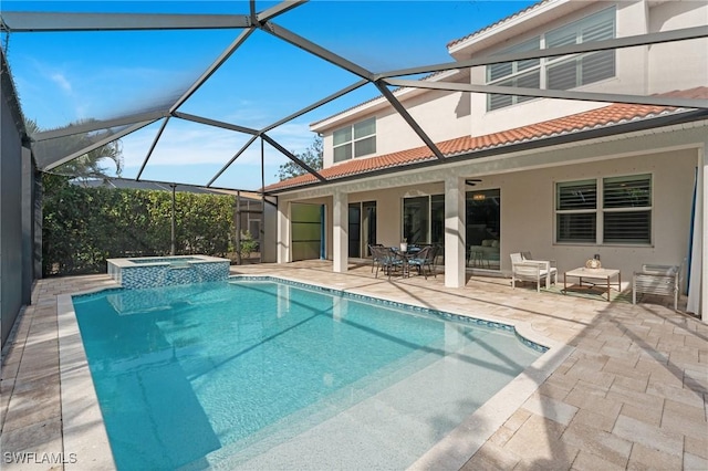 view of swimming pool featuring a lanai, a patio, and an in ground hot tub