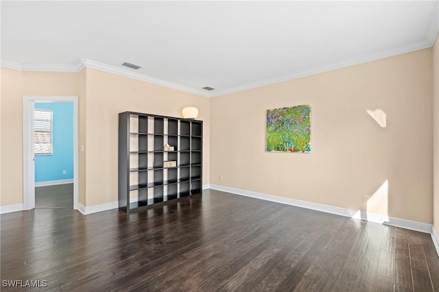 unfurnished room featuring crown molding and dark hardwood / wood-style flooring