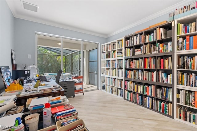 office area with crown molding and light hardwood / wood-style floors