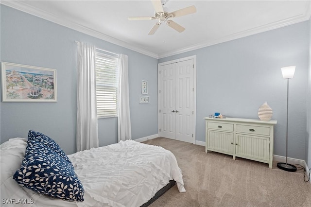 carpeted bedroom with ornamental molding, ceiling fan, and a closet