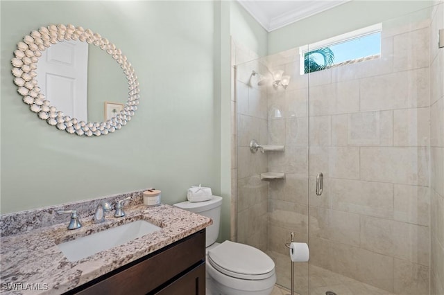 bathroom with an enclosed shower, vanity, ornamental molding, and toilet