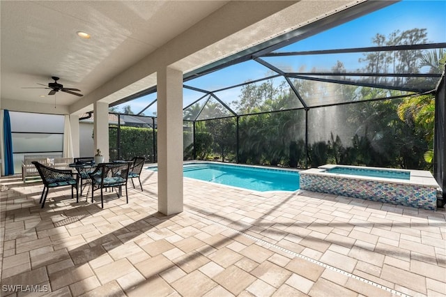 view of pool featuring a lanai, a patio, ceiling fan, and an in ground hot tub