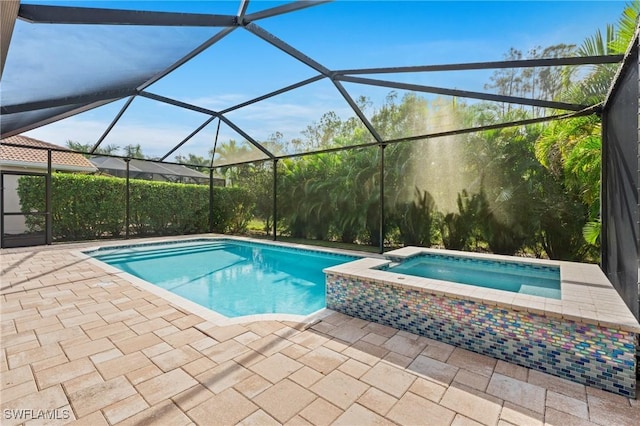 view of swimming pool featuring an in ground hot tub, a lanai, and a patio