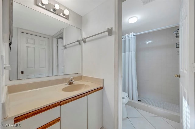 bathroom with a shower with shower curtain, vanity, toilet, and tile patterned floors