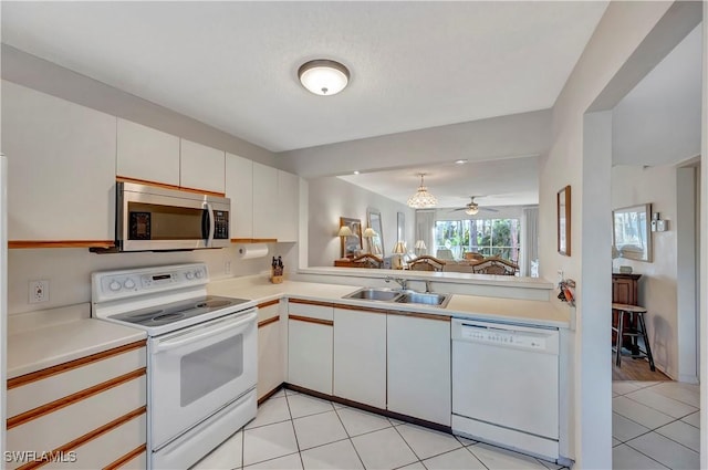 kitchen with ceiling fan, sink, light tile patterned flooring, white appliances, and white cabinets