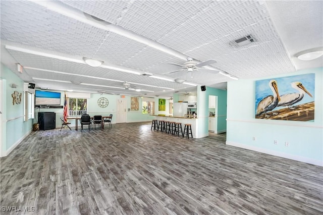 unfurnished living room featuring hardwood / wood-style floors and ceiling fan