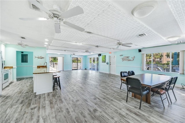 dining room with ceiling fan and light hardwood / wood-style floors