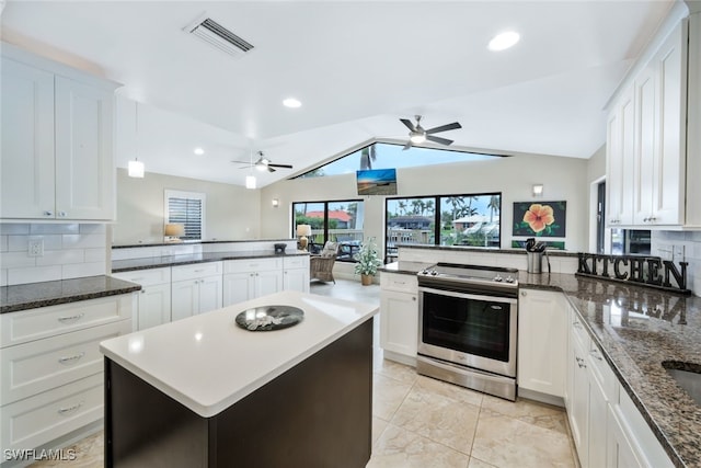 kitchen featuring stainless steel electric range, a center island, lofted ceiling, kitchen peninsula, and white cabinetry