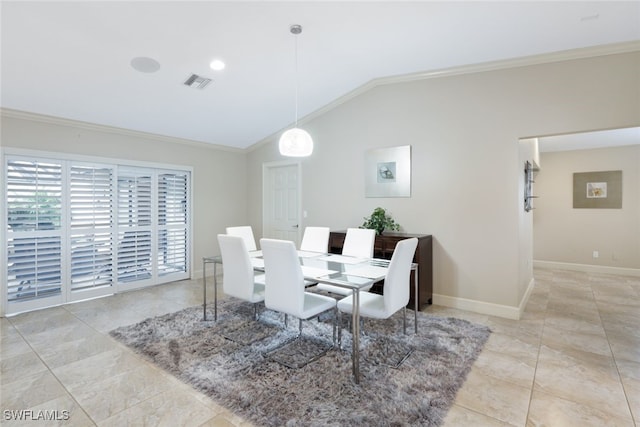 dining area with lofted ceiling and ornamental molding