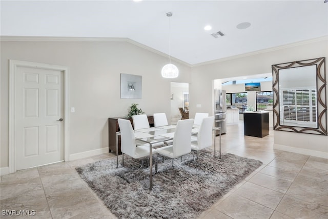 dining area with lofted ceiling and ornamental molding