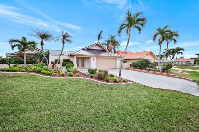 view of front of house featuring a front yard and a garage