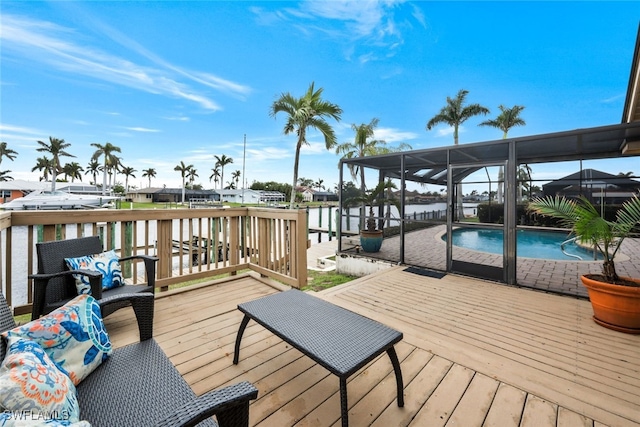 dock area with a pool side deck with water view and a lanai