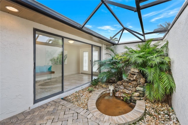 view of patio / terrace featuring a lanai