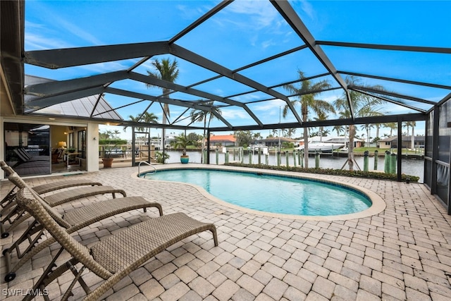 view of swimming pool with glass enclosure, a patio area, and a water view