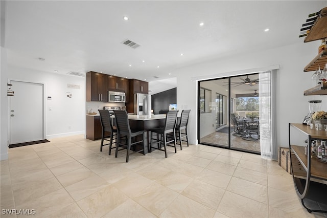 dining room with light tile patterned flooring and ceiling fan