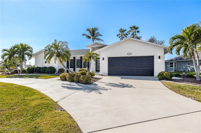 single story home featuring a garage and a front lawn