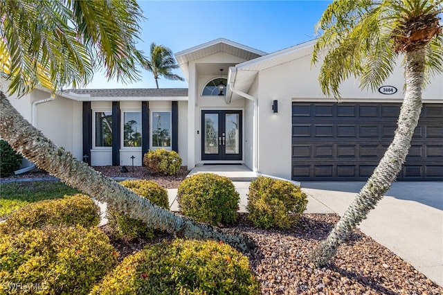 property entrance with a garage and french doors